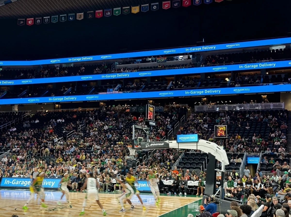 Amazon Key In-Garage Delivery banners inside Climate Pledge Arena during a game.